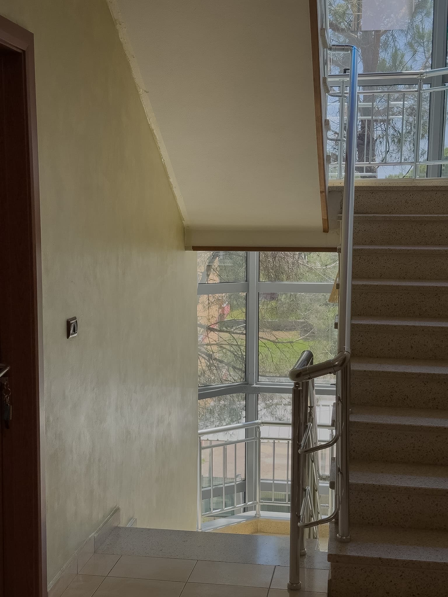 Bright stairwell with tall windows and garden light