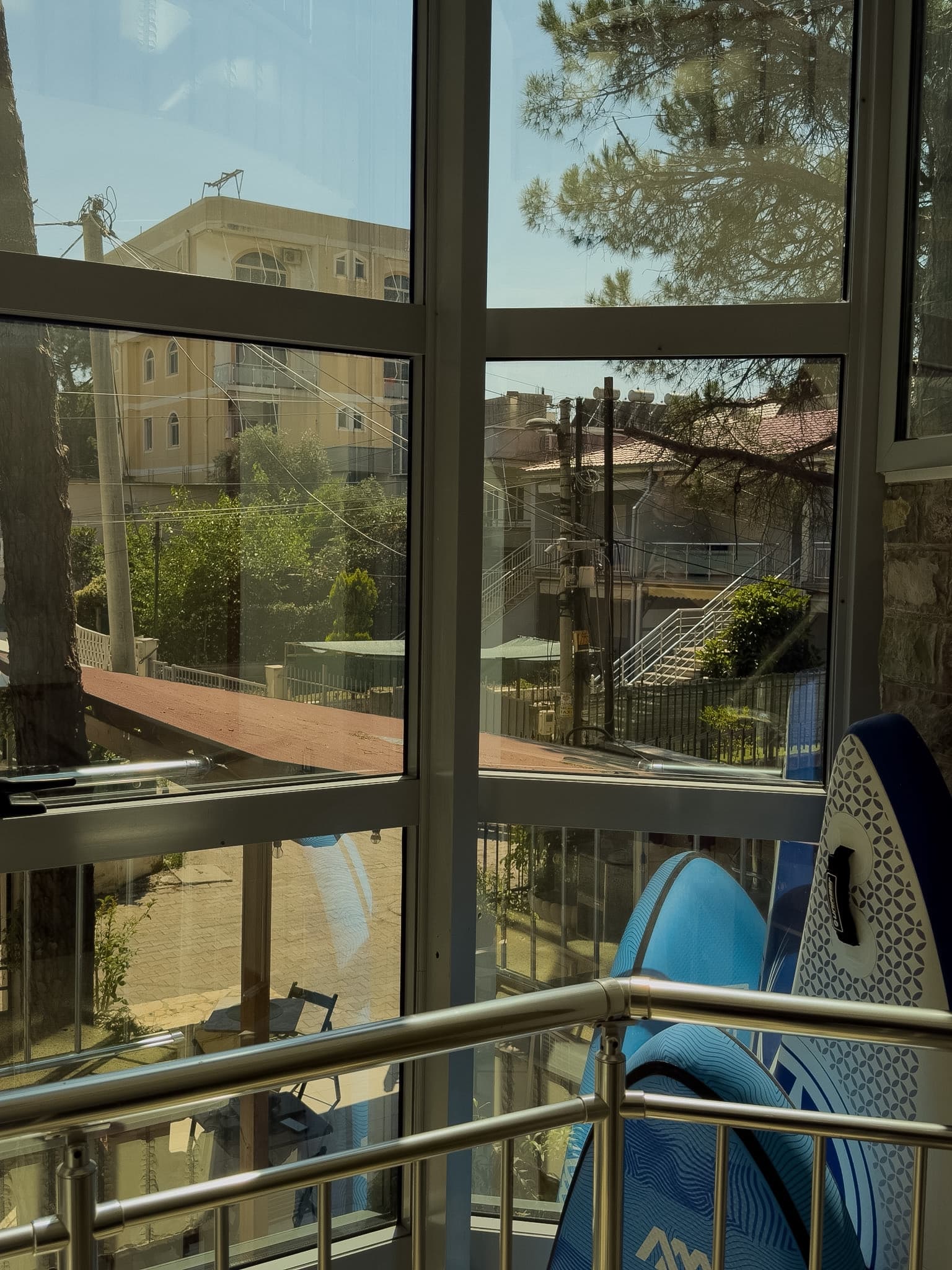 Window corner with water-sport boards and a neighborhood view